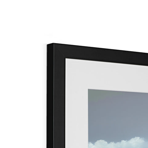 A picture frame with a black mirror and white frame sitting on top of a window.