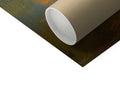 A white and green paper roll on a white wall next to black cloth.