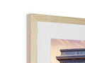 A wooden photo is pictured in a frame that is on a table.