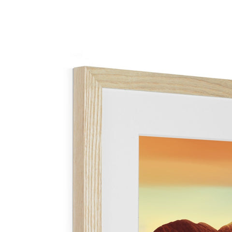 A wooden picture frame with a photo of a sunset in it.