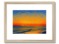 An art print depicting a beach with a sunset with people sitting there watching the surf.