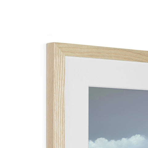 A picture frame that has a view of a city skyline and trees.
