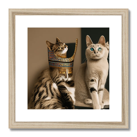 Two cats standing on a shelf holding a framed picture of the pharaoh's mask.