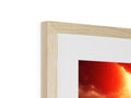 A red and white photo of photos hanging in a wooden frame.