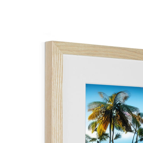 A picture of a tree has wood framed next to a white background.