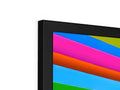 a flat screen TV on a shelf with different colors that are all painted on it