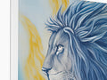 A painted image of lions standing atop a fireplace mantle next to a white book.