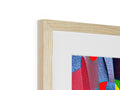 An art print wrapped in wood in a wooden frame on a table.