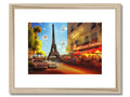 An art print with a frame next to an image of the Eiffel Tower on