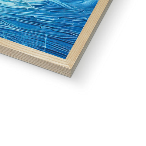 A picture frame sitting next to a wood cutting board and a blue framed glass painting and