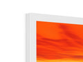 A flat screen display sitting on top of an Apple desktop with orange and red colors.