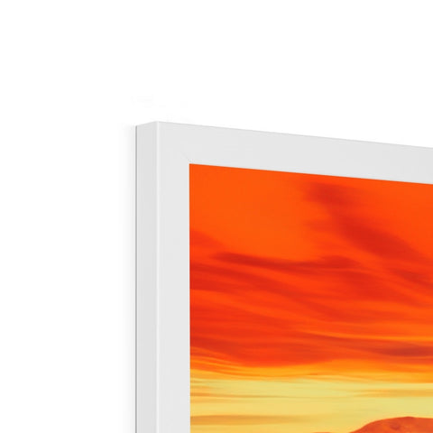 A flat screen display sitting on top of an Apple desktop with orange and red colors.