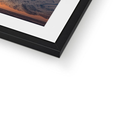 A photograph is mounted on top of a picture frame in a frame.