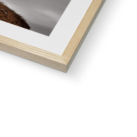An image of a photo of a dog on a wooden frame is on a table.