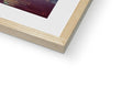 A photo is sitting on top of a wooden frame next to a metal book.