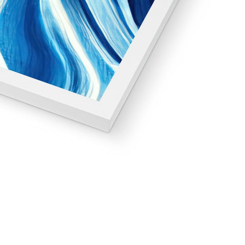 An imac, large picture of an iceberg on a wall next to some books.