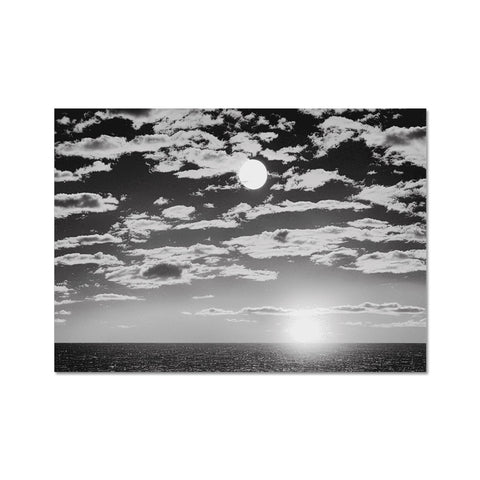 A black and white photo of a sunset at sunset in the mid-length setting.