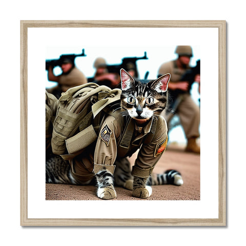 A cat posing underneath a framed photograph of a soldier holding a gun on an arm.