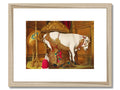A photo of a female equined horse sitting in front of gold framed artwork is hanging