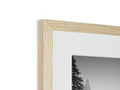 A picture frame for a wooden mirror with a photograph is in it.