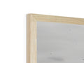 A white picture frame on top of a wooden table with a mirror.