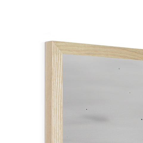 A white picture frame on top of a wooden table with a mirror.