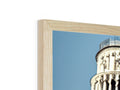 A wooden picture of Pisa in front of a black mirror.