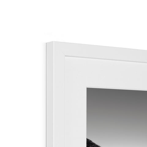 A white picture frame is hanging on a frame with a glass mirror.