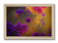a large colorful flower photo on top of a wooden frame laying on a table