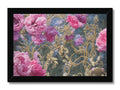 A framed art print of pink flowers hanging on the side of a table.