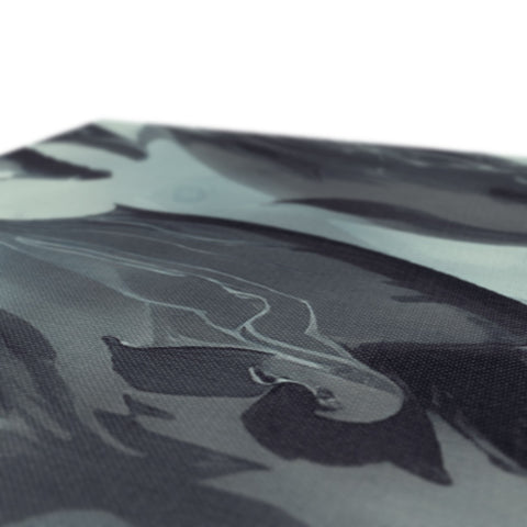 Close up of car hood wrapped with a printed umbrella on a bench.