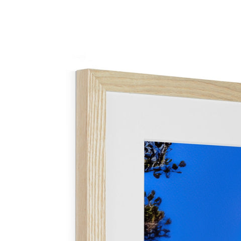 A blue wooden frame with a small picture hanging from the frame.