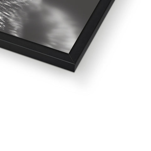 A rectangular picture frame with a black wall of a white picture.