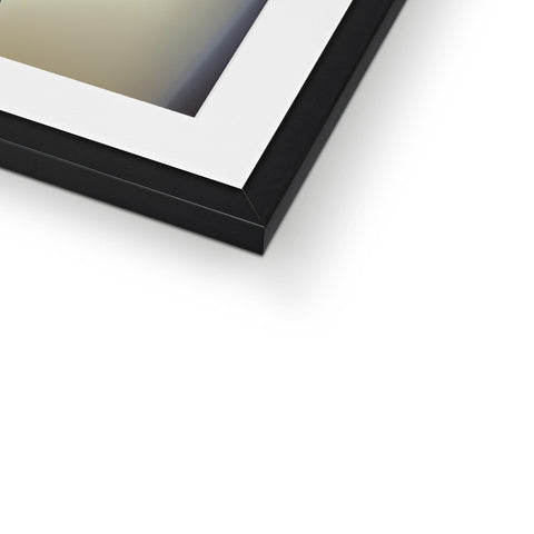 A picture frame has a couple of light and dark objects within it.