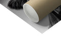 A rolled TP roller laying on a table behind a toilet on a black and white picture