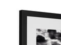 Cloud with a black and white picture frame hanging next to a monitor mounted on top of