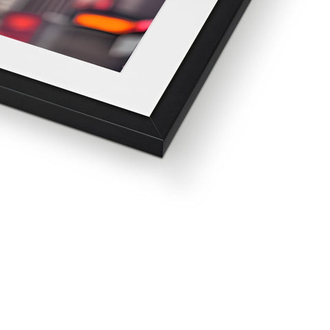 A framed photograph of a photo on a white background next to electronics.