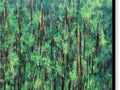 A tree covered forest with green trees in the background with some cattails and a