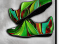 An abstract design is painted on a shoe with a dragon sitting on it