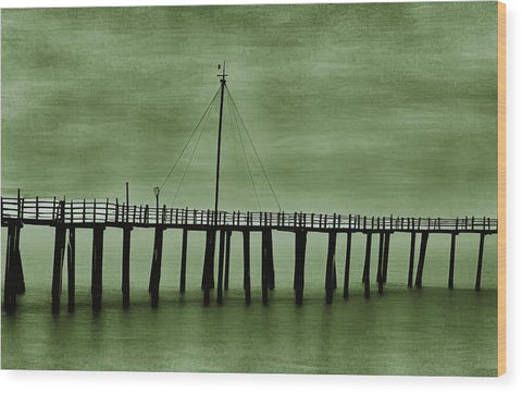 A pier with an art print on the side of it next to a water body.