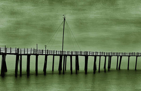 A green boat on a wooden bridge under the ocean