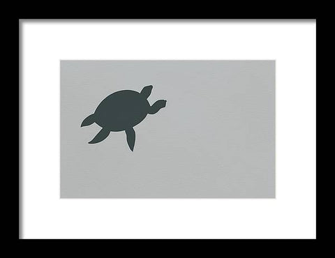 A turtle sits on top of a pond with an art print on the wall.