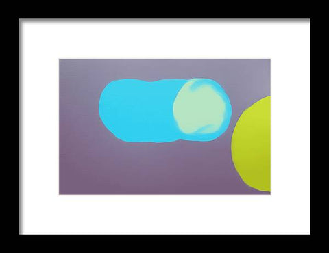 An image of a blue and green plastic tennis ball on an art print.