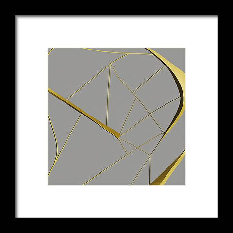 a gold framed art print with geometric design that is hanging in a wall