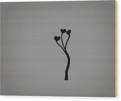 This is a silver metal carving with a apple sticker on a wooden cutting board.