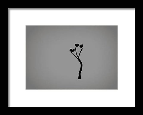 A flower sticking to the side of a wall in black and white art print.