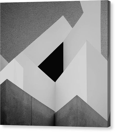 A wall that has a number of vertical triangles with a black and white photograph as it