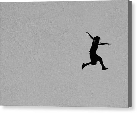 Man jumping off of a skateboard over a ledge in the sky
