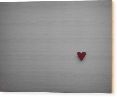 A white metal cutting board with a red heart in the corner of a green paper file