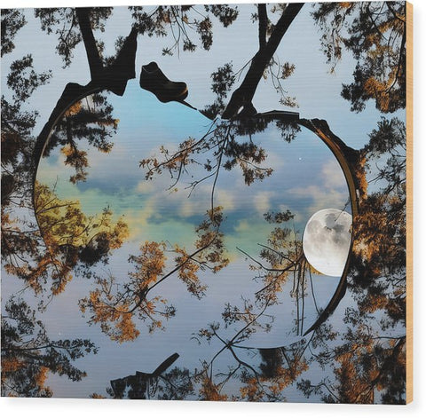 An art print on wooden wall hanging on an outdoor table beside a mirror.